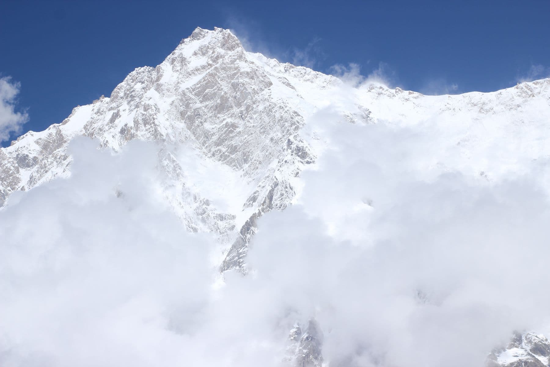 Snow-covered Nanga Parbat surrounded by clouds